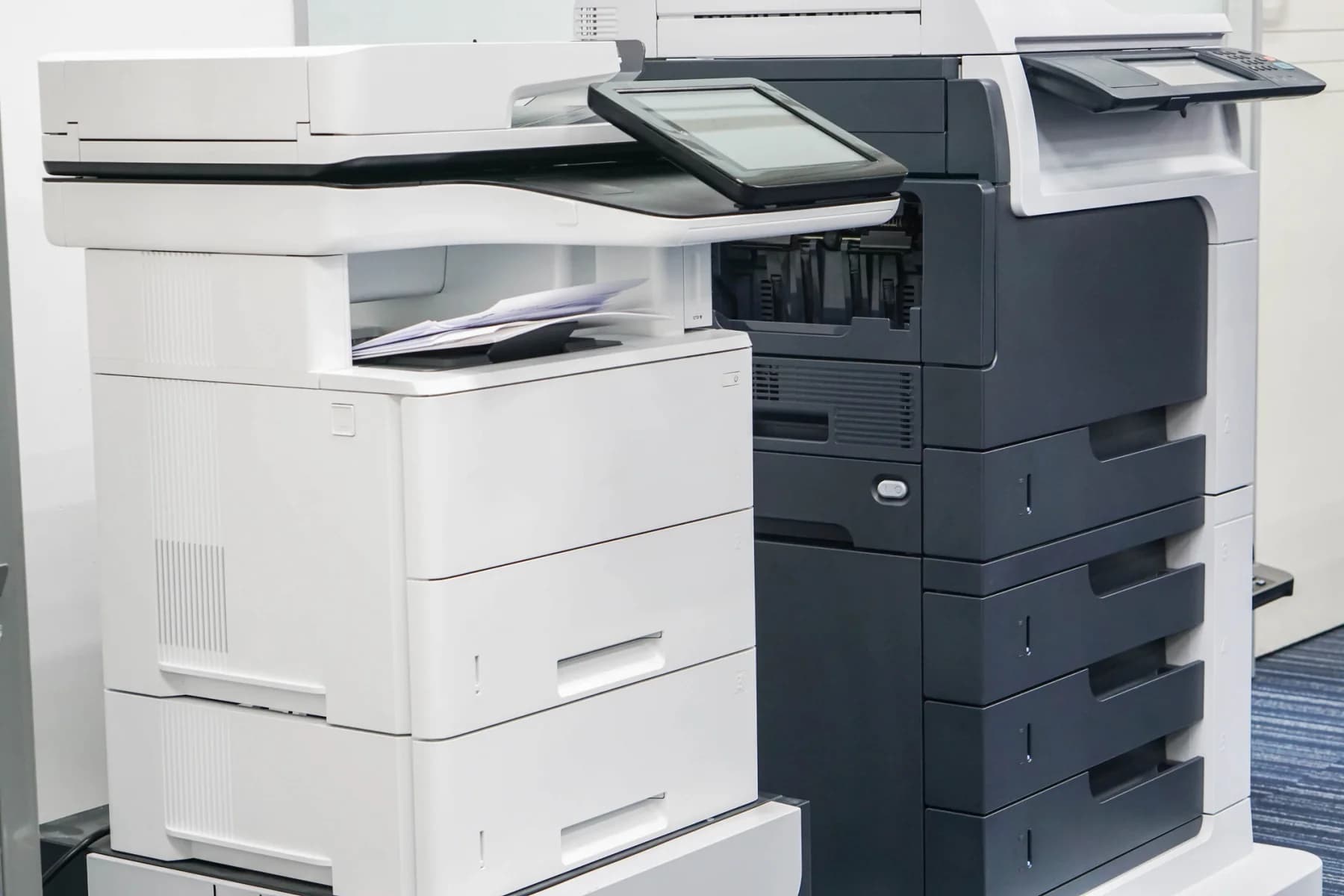 Modern office copier in a bright office environment for temporary printing, copying, and scanning workflows