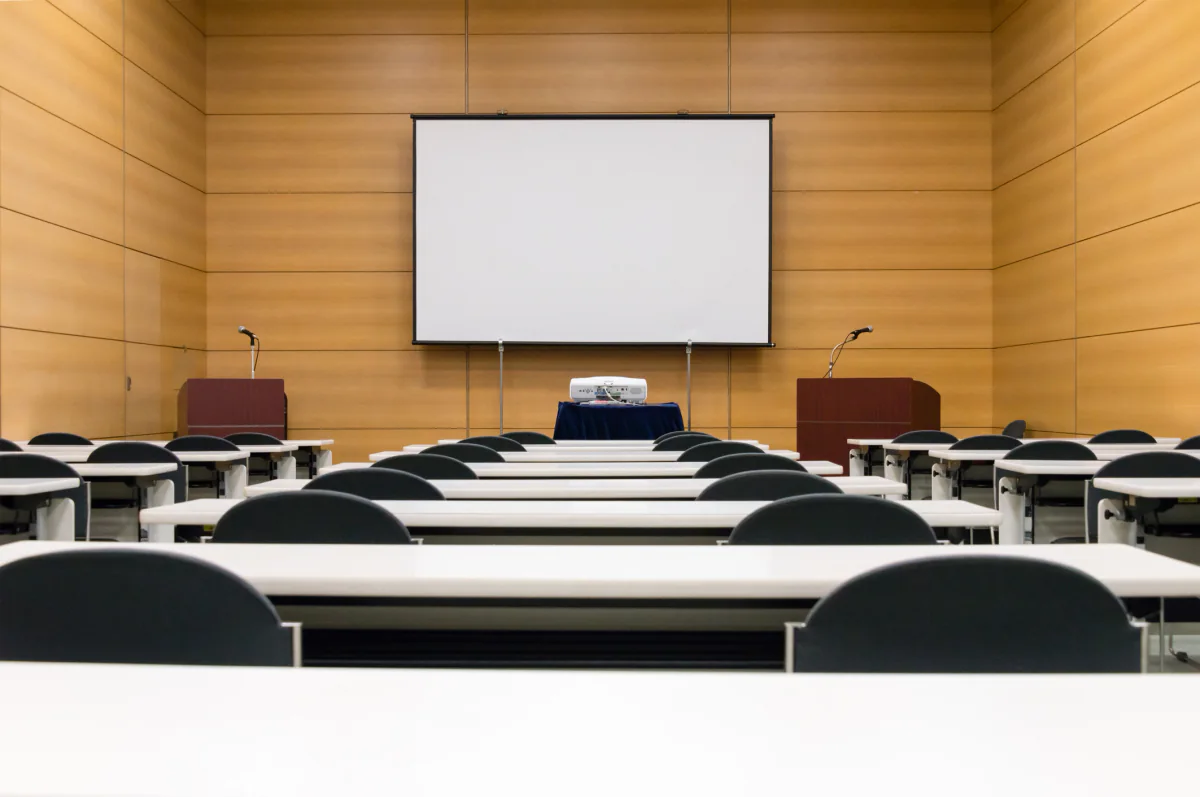 Meeting room audio visual rental package with projector screen speakers and microphones for business presentations