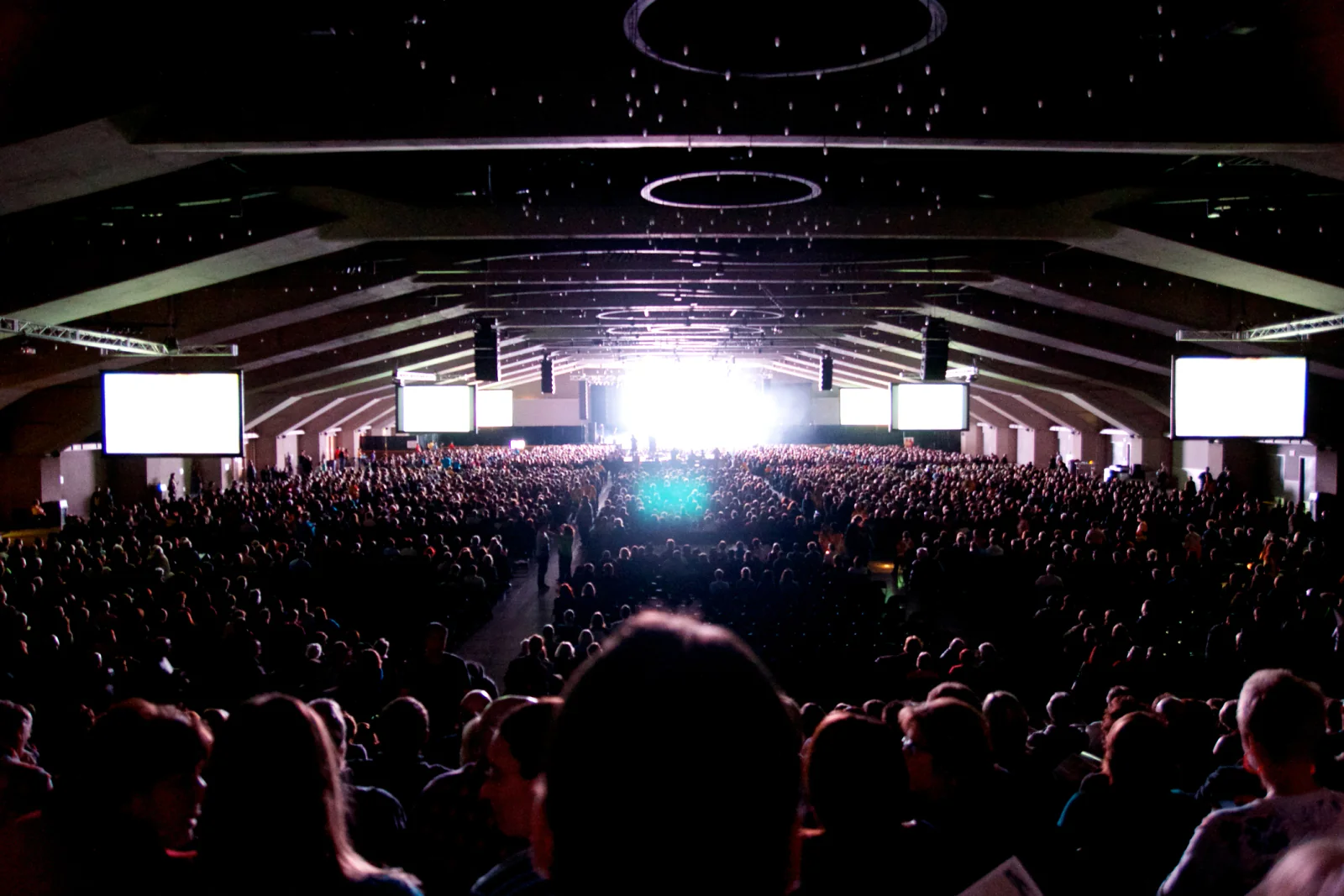 Event stage lighting with colored uplighting and presentation wash for keynote and panel environments