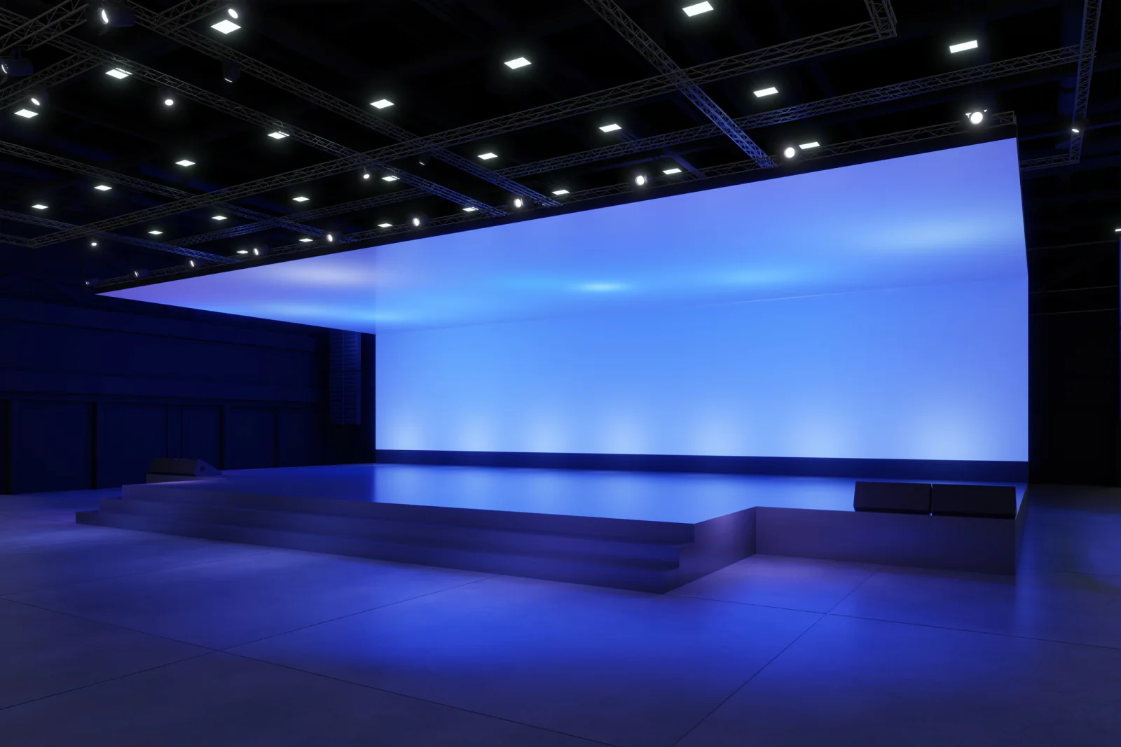 Stage wash lights illuminating a presenter on a conference or keynote stage