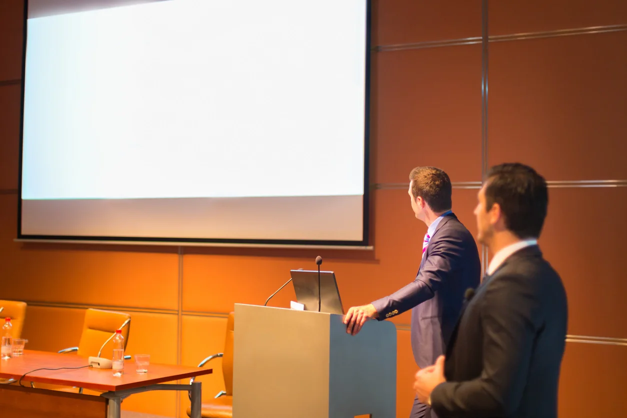 Projector and projection screen set up in a corporate conference room for training and presentation use