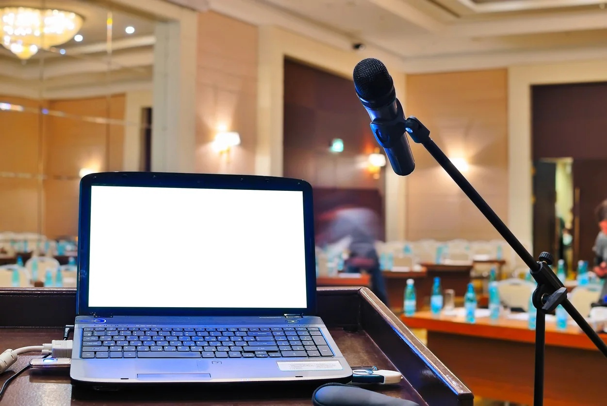 Speakers and audio mixer set up for a corporate event presentation in a ballroom or meeting room