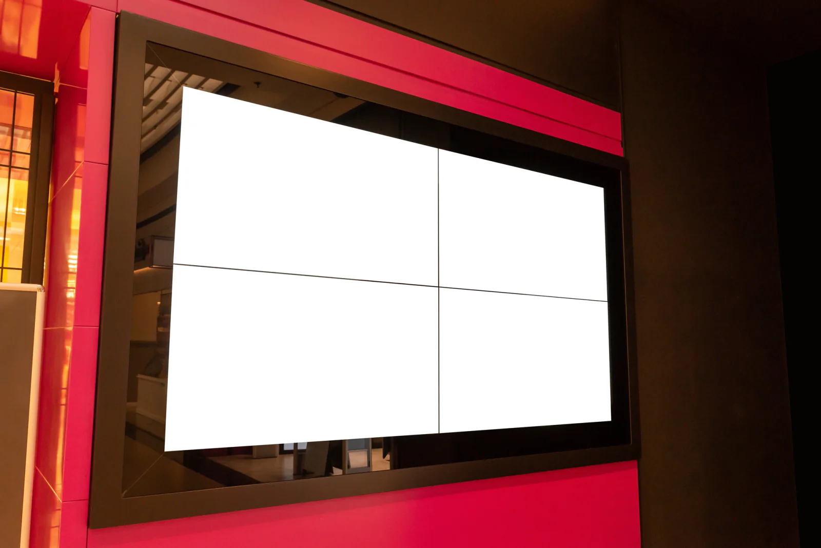 2x2 LCD video wall in a booth or lobby environment displaying branded event content