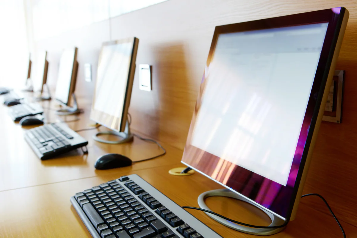 Apple iMac desktop computers set up in a creative studio and media production workspace