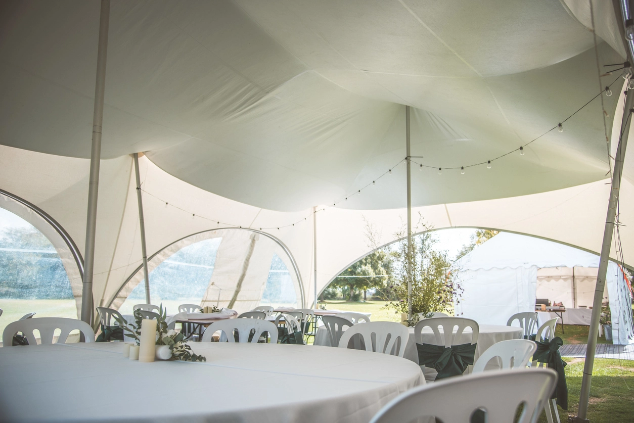 Finished professional event tent interior with seating tables lighting and hospitality space