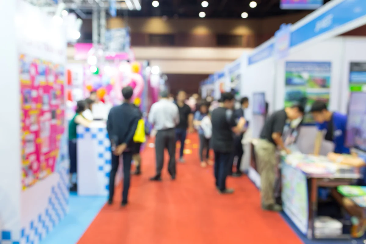 Lead generation focused trade show booth with rental tablets displays scanning tools and staff engaging attendees