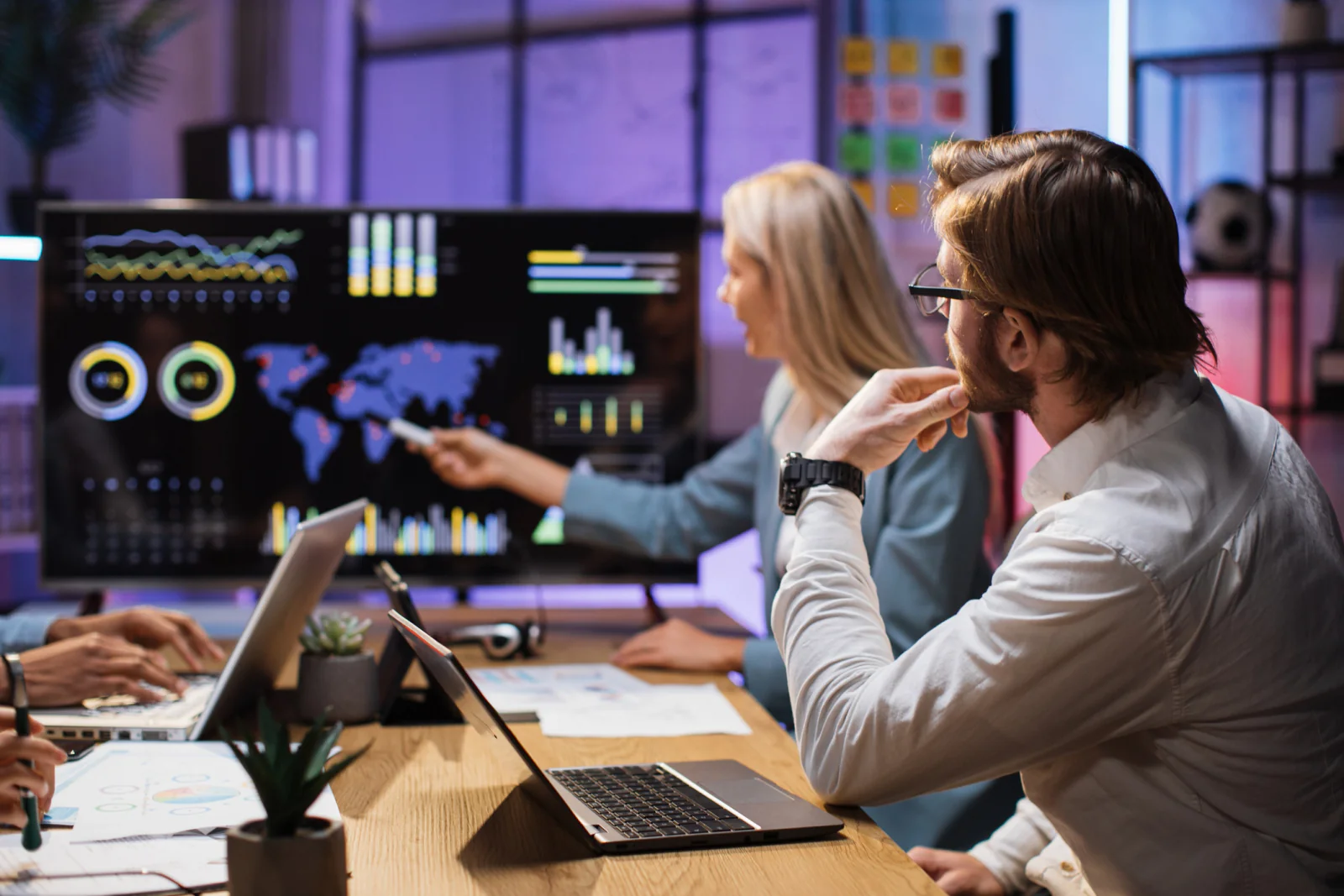 Campaign war room with staff monitoring dashboards, social feeds, and election data on multiple large screens