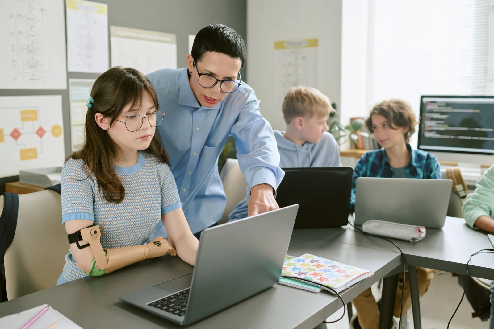 Summer learning classroom with students using laptops and tablets for STEM and enrichment activities