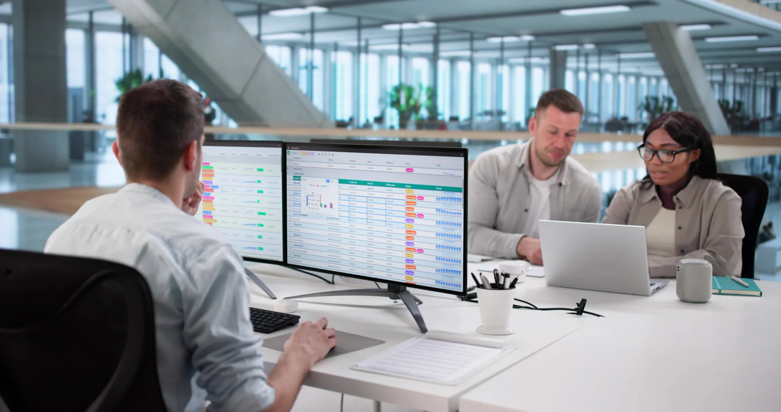 Temporary financial services office with dual-monitor workstations, printers, and staff continuing operations during a business continuity event