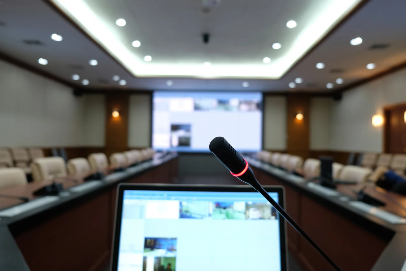 Corporate meeting room with projector screen speakers and microphones for training and presentation sessions