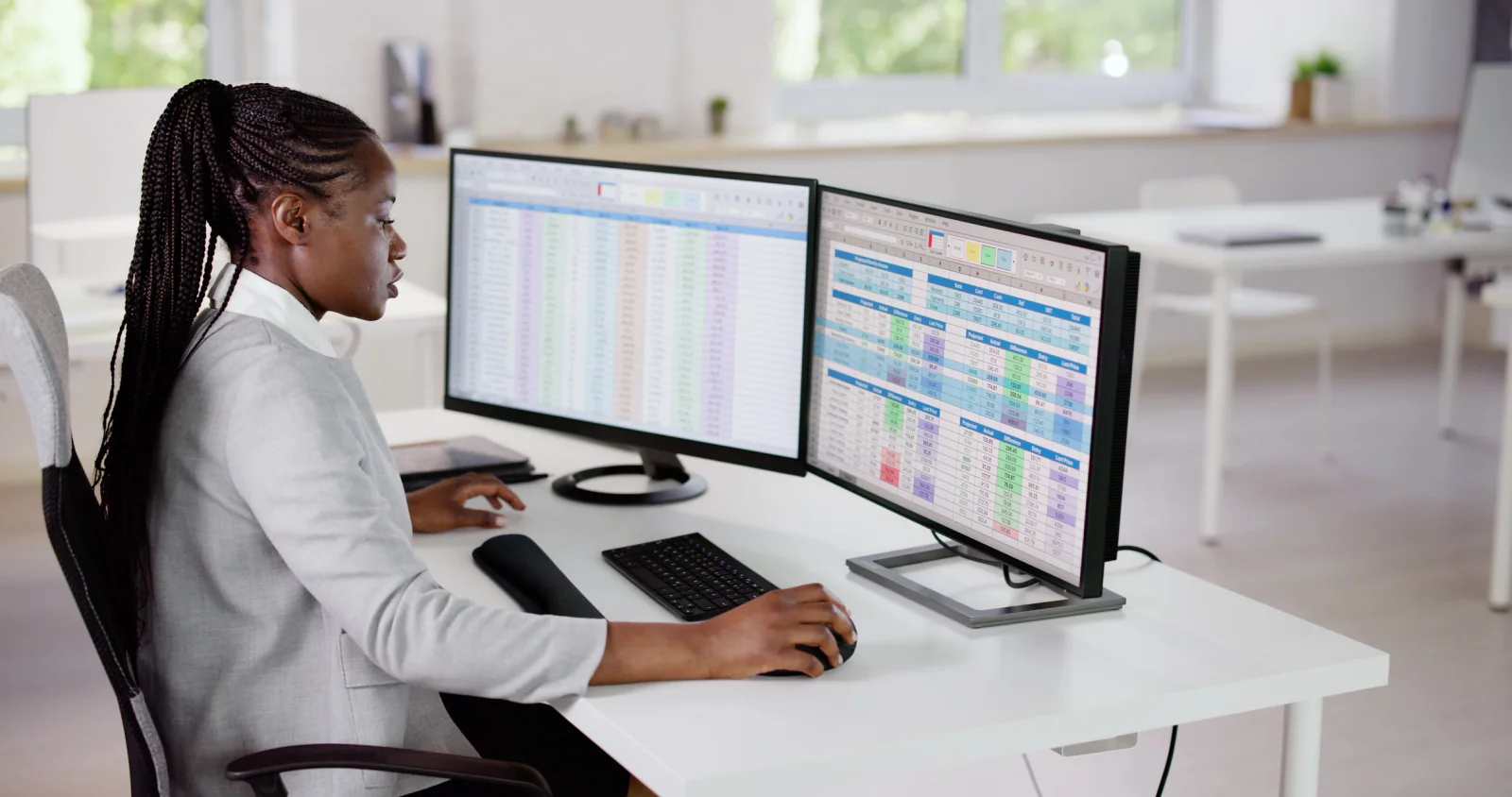 Legal document review center with attorneys working at dual-monitor workstations