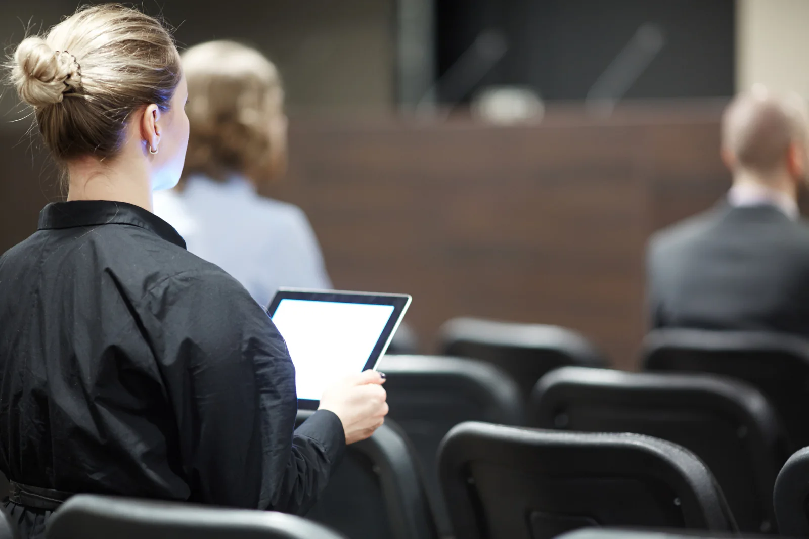 Nonprofit staff and volunteers in a training room using laptops and a projector