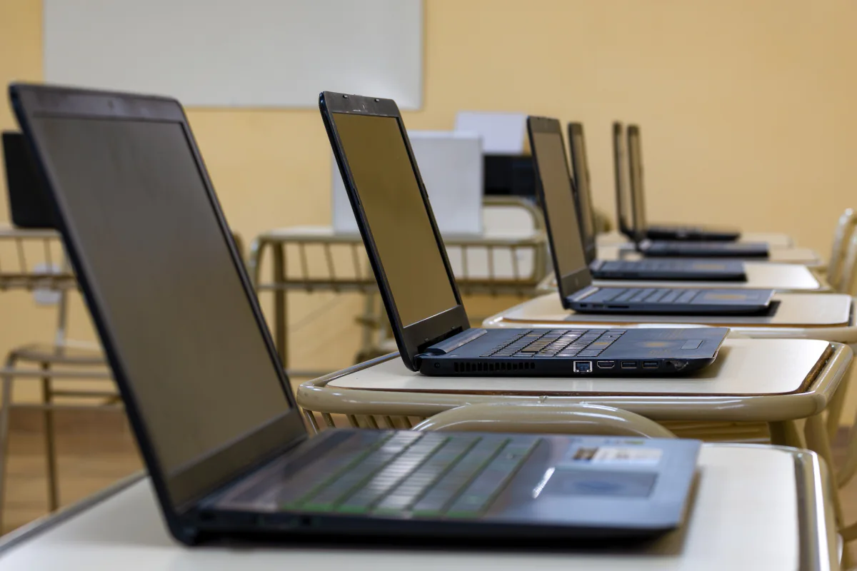 Chromebooks arranged in a classroom and testing center layout for browser based training and assessments