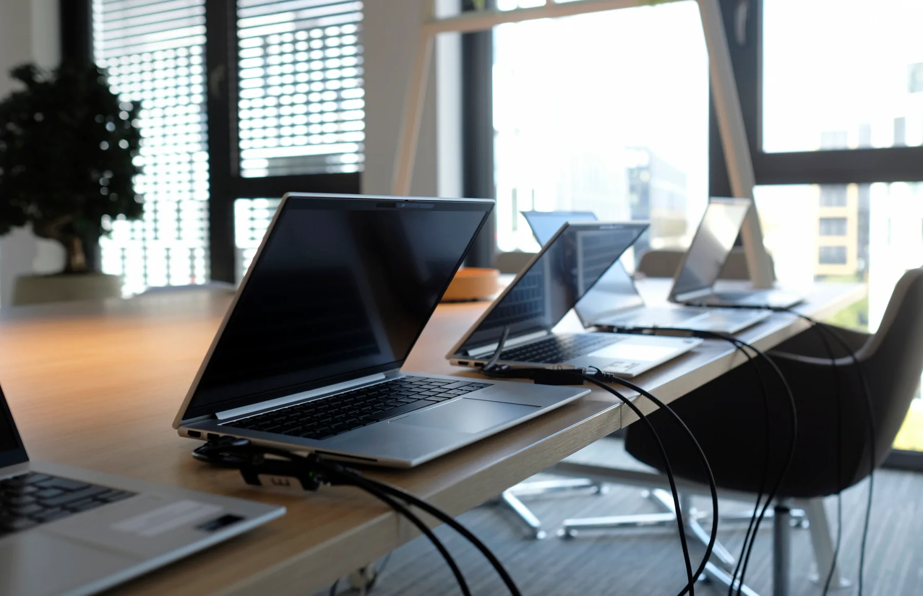 Business laptop rentals in a corporate training room with attendees using laptops at classroom tables