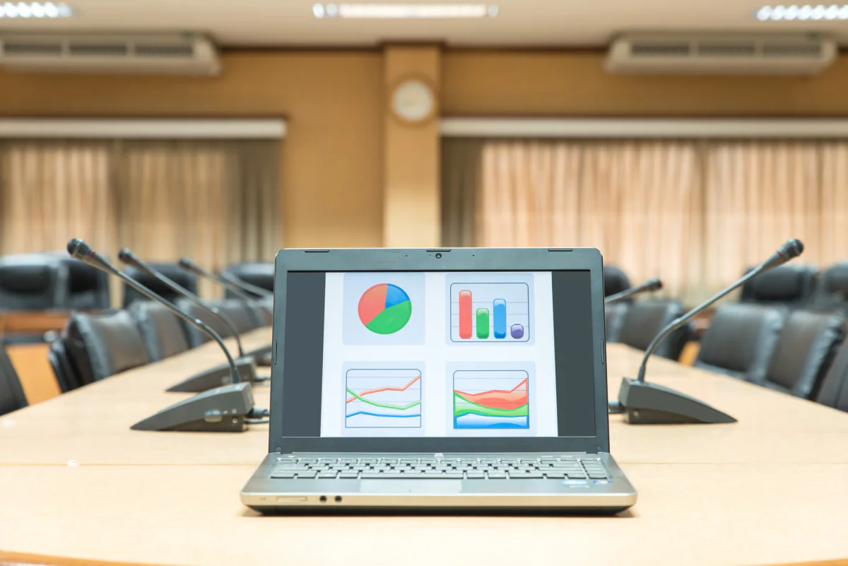 Apple MacBook Pro laptops on a modern conference table for creative teams and executive presentations