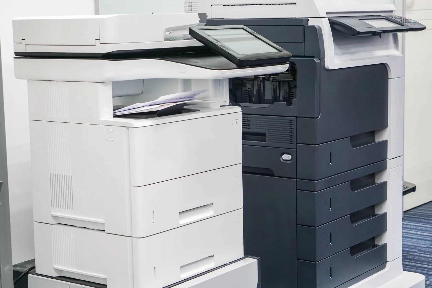 Modern office copier in a bright office environment for temporary printing, copying, and scanning workflows