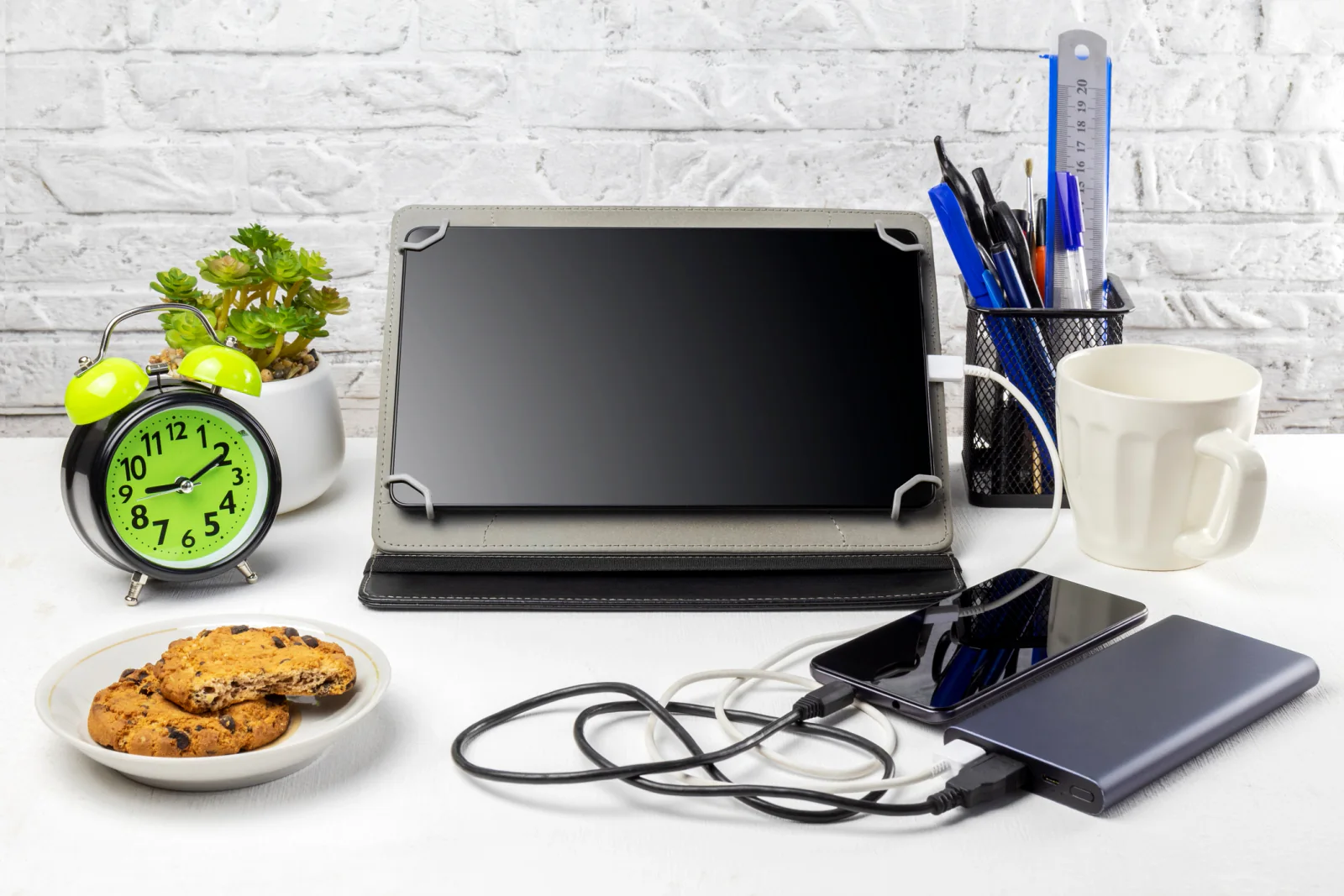 Adapters, hubs, chargers, and cables laid out on a table for temporary office and event station planning