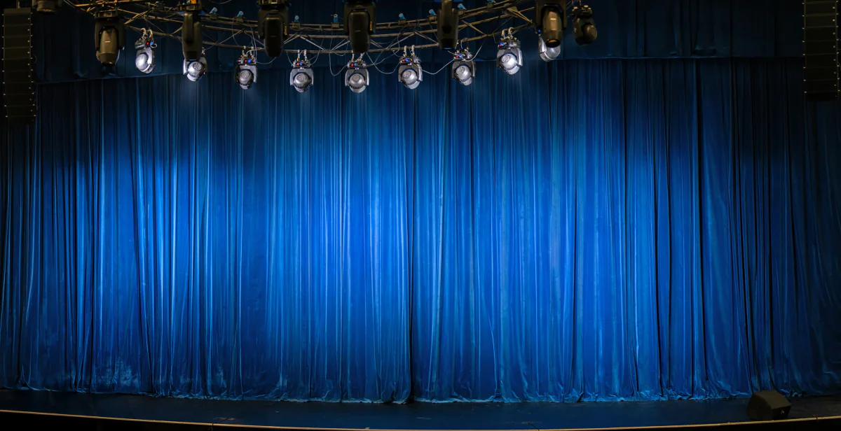 Pipe and drape stage backdrop setup for keynote presentation sponsor branding and formal event use