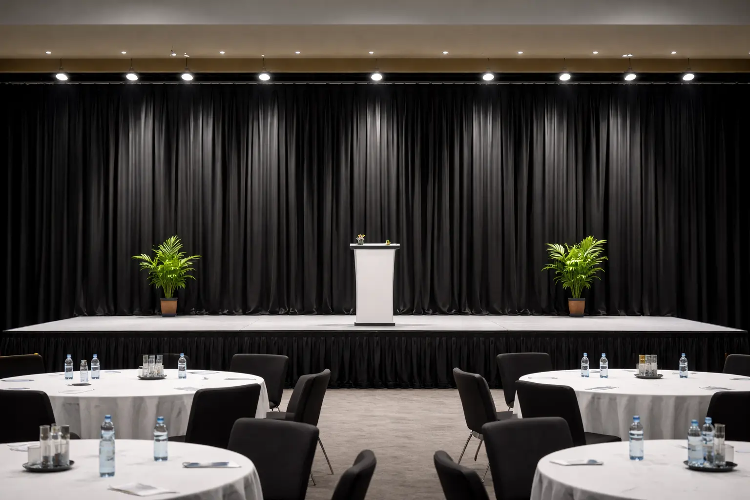 Pipe and drape backdrop behind a stage for keynote presentations sponsor walls and event photo opportunities