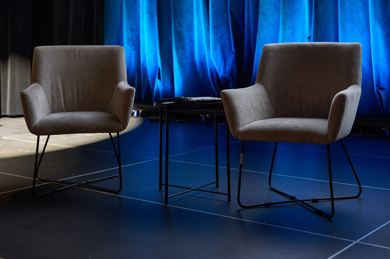 Bar stools and networking tables arranged in a trade show booth