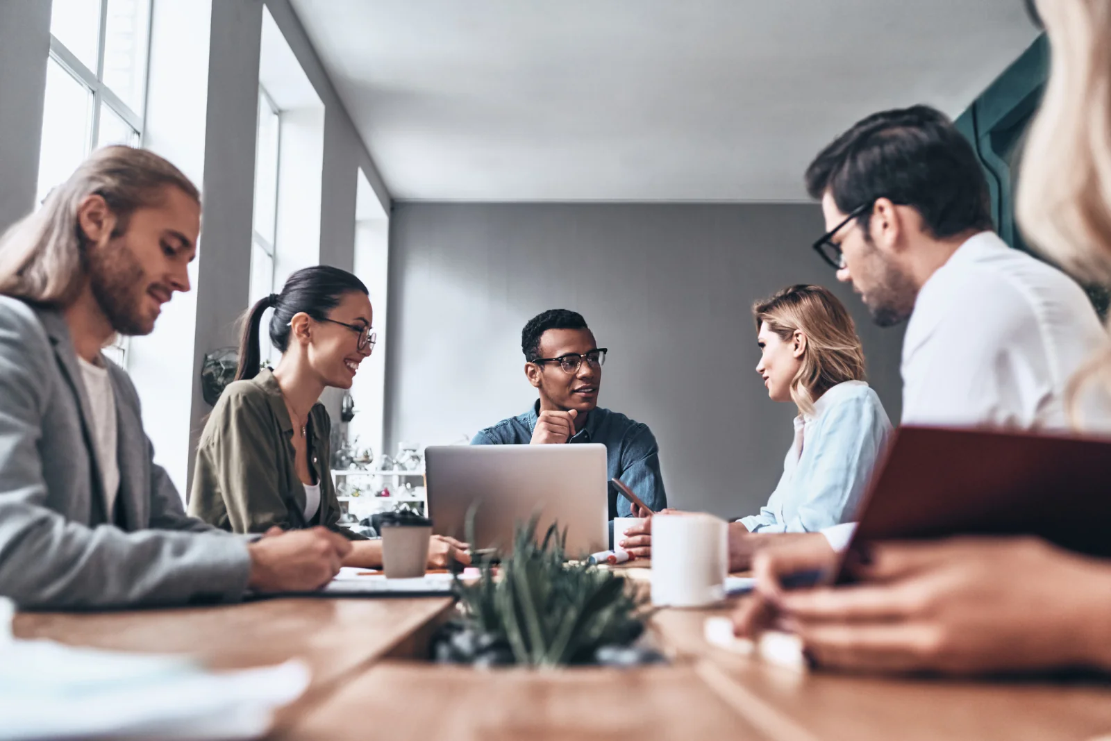 IT and operations leaders coordinating a business technology transition with laptops, planning documents, and migration checklists