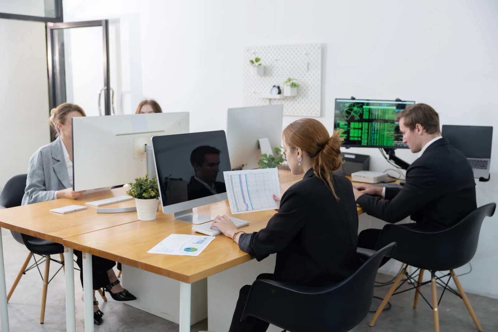 Back-office event support area with printers, laptops, monitors, and temporary office equipment for registration and administration