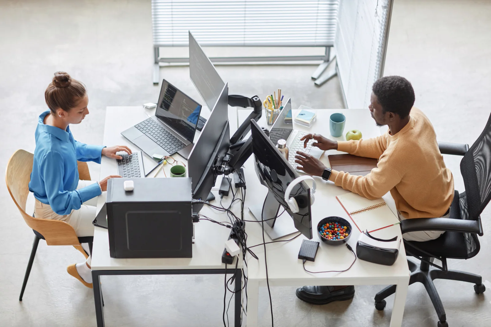 Temporary business workspace with spare laptops, monitors, chargers, and support equipment staged for day-one readiness and contingency planning