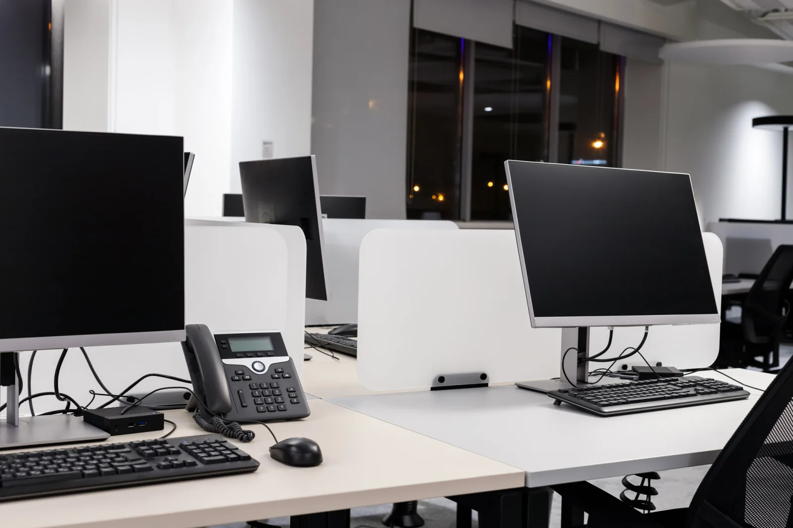 Shared office print and scan station with printer, scanner, laptops, and document workflow equipment in a temporary workspace