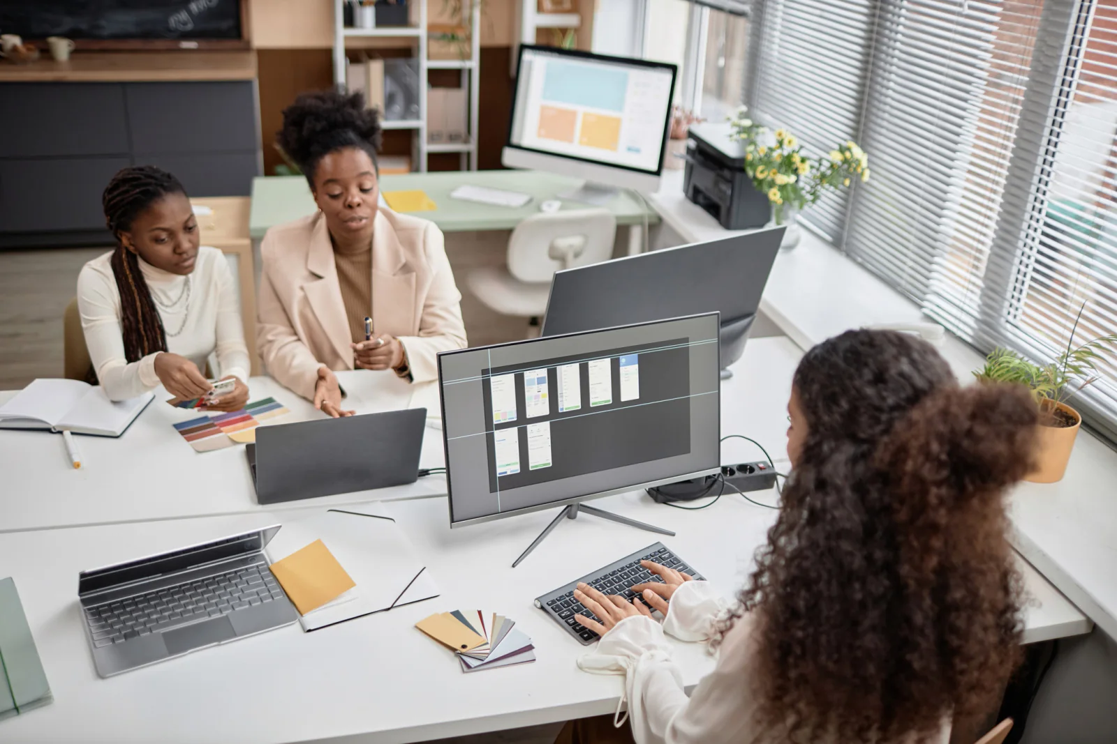Standardized technology kits with laptops, monitors, chargers, keyboards, and accessories staged for a business rollout