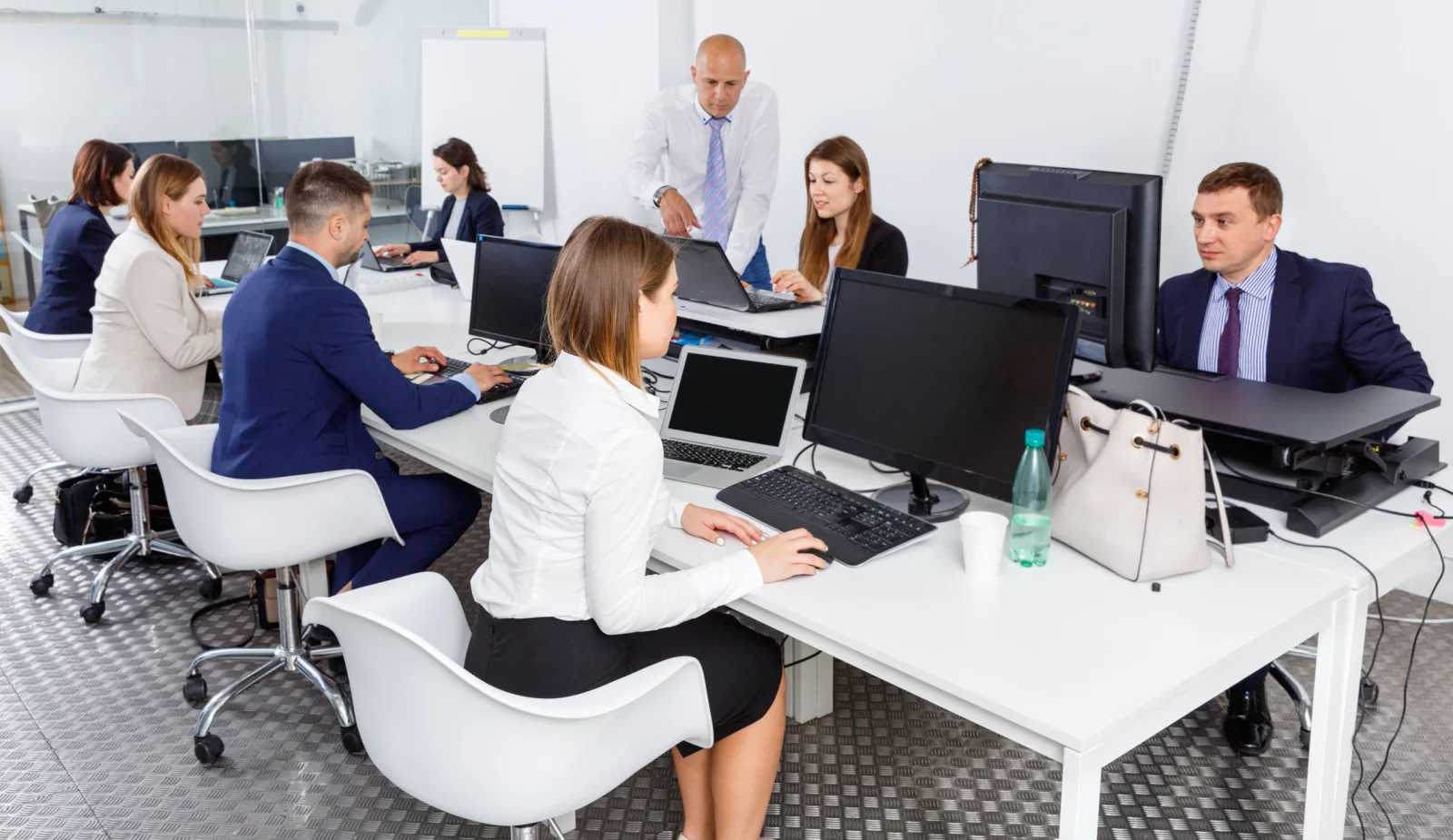 Multi-location technology rollout plan with laptops, schedule boards, site checklists, and deployment coordination across several business locations