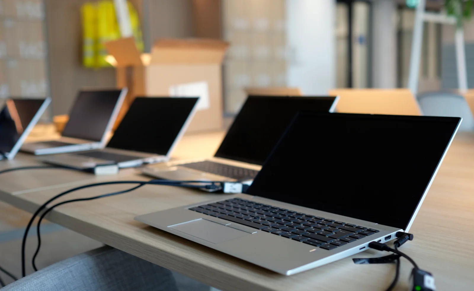 Temporary office with standardized laptops, monitors, printers, and accessories staged for a short-term business team