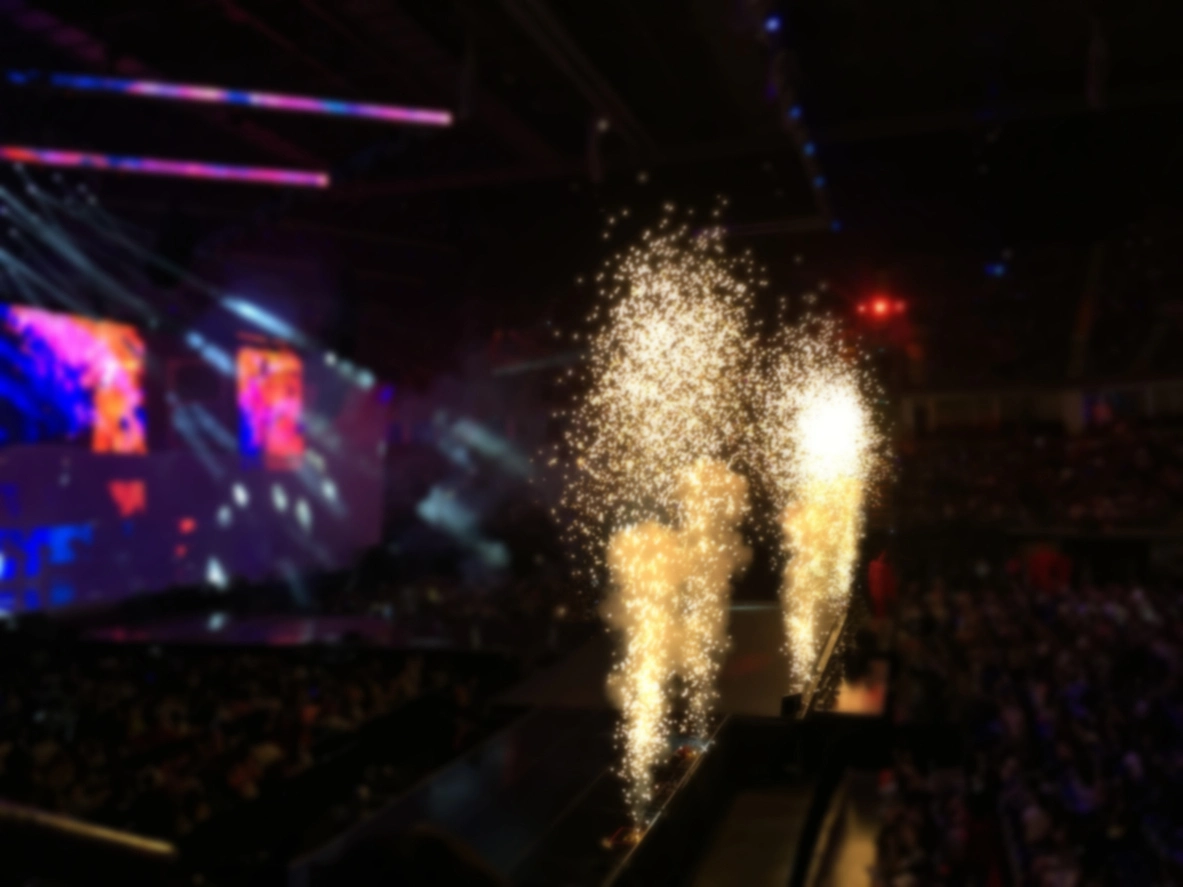 Cold spark machines creating controlled vertical spark effects around a professional event stage