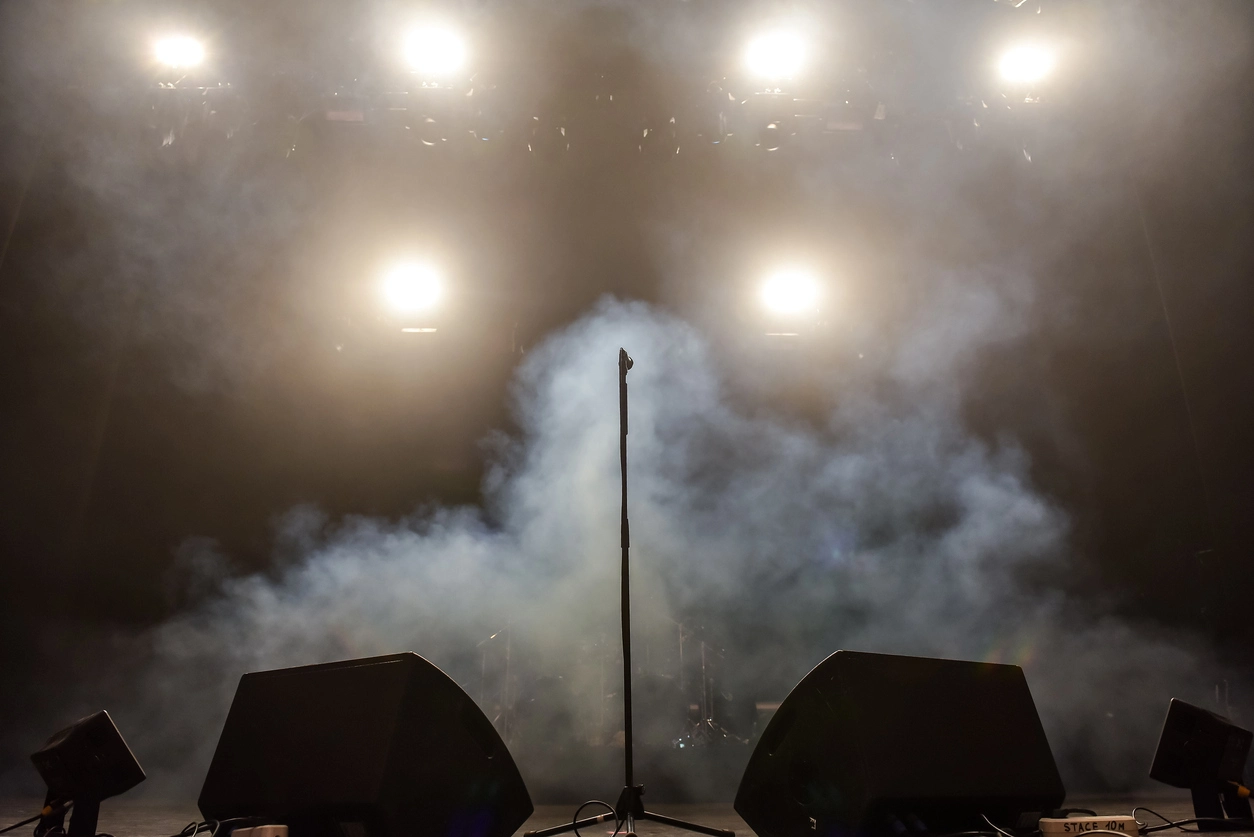 Low lying dry ice and fog effect across a professional event stage during a live production