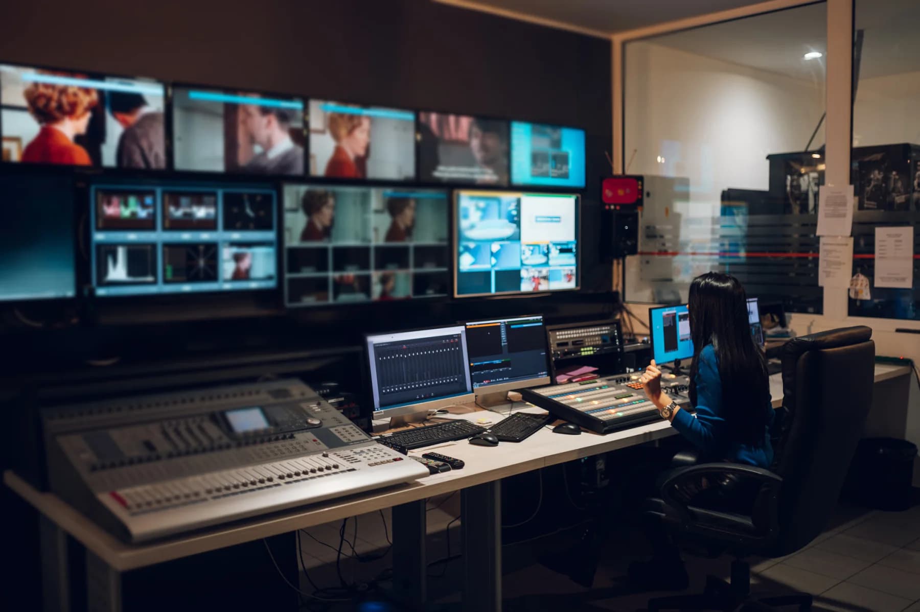 Broadcast control room with operators managing multiple screens during live production