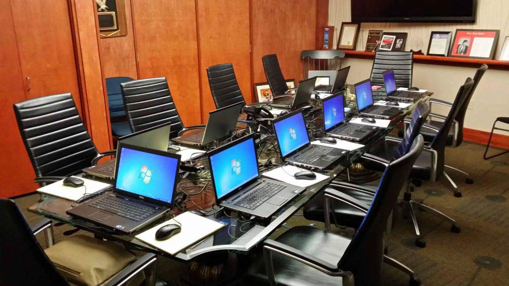 Rented laptops around a conference table