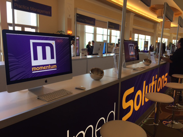 An Apple iMac set up in a convention booth