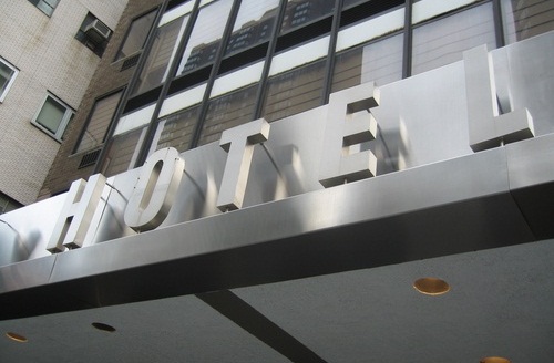 A sign above a doorway indicating that the building is a hotel
