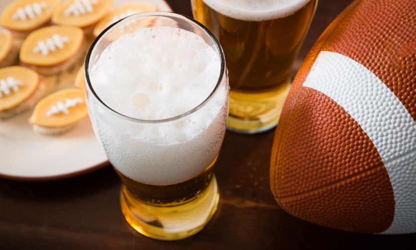Super bowl tech takeaways A football sitting next to some snacks.