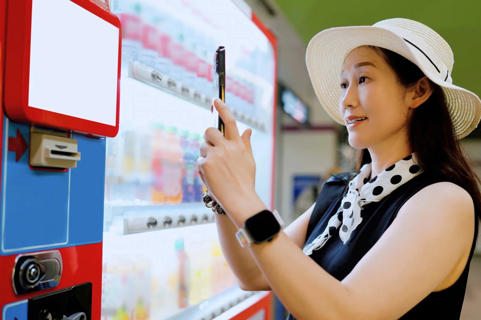 Branded vending machine in a trade show booth dispensing giveaway items and attracting attendee engagement