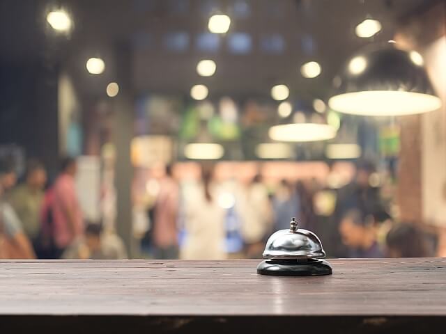 A service bell on a counter in a busy lobby