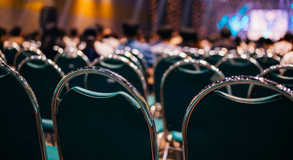 Lines of chairs facing a large stage