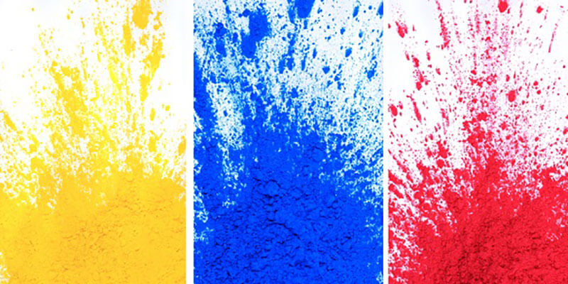 A side by side by side view of splashes of printer ink in the yellow, cyan, and magenta ink colors