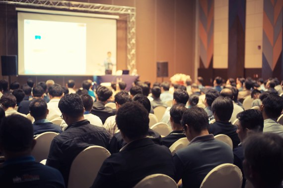 A crowd of people watching a presentation