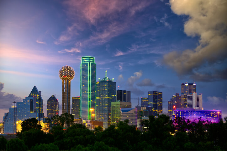 A futuristic looking skyline with buildings outlined with colorful LED lighting