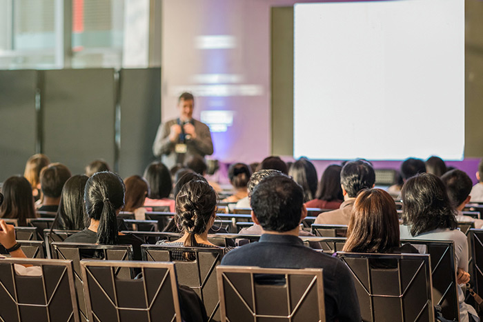 a individual giving a presentation in a classroom like setting
