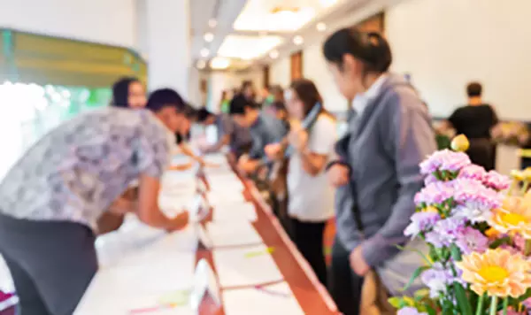 A guest being attended to at an event registration desk