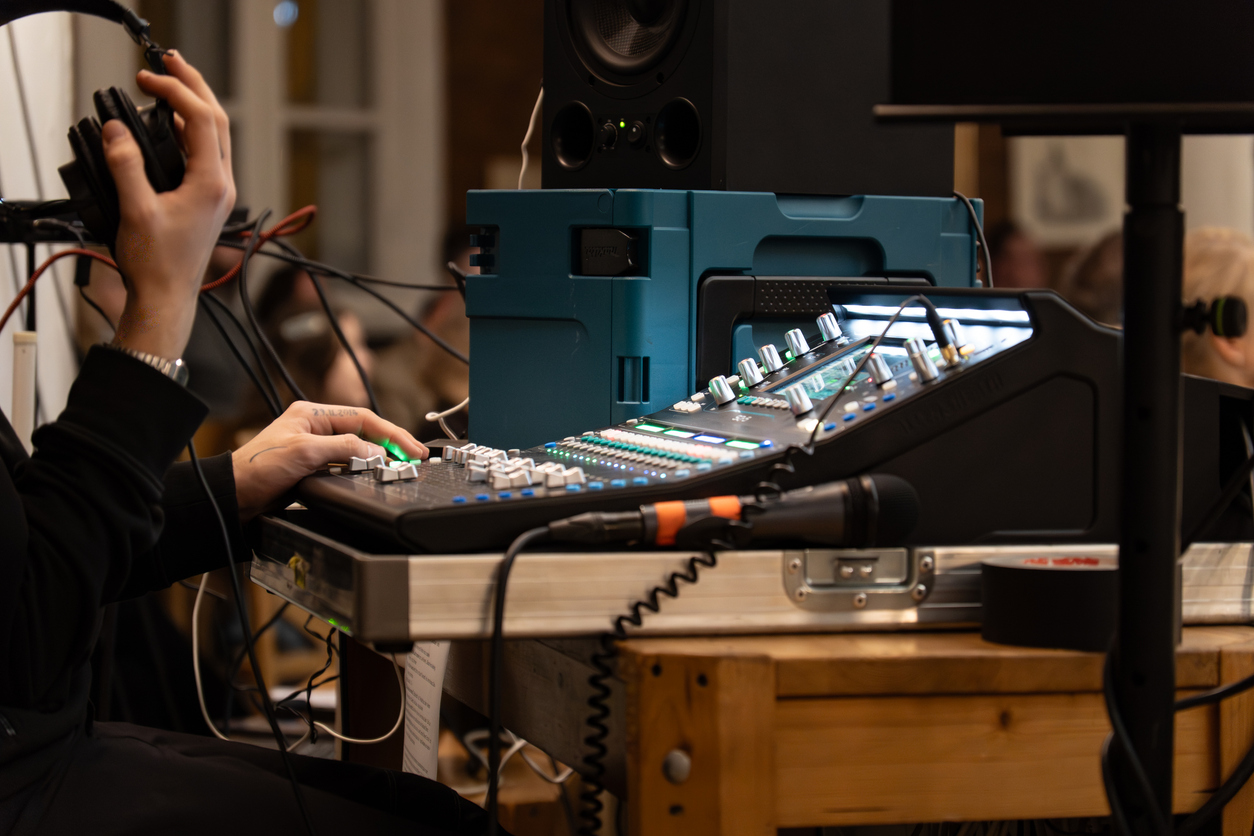 Event technician setting up AV and interpretation equipment before a conference