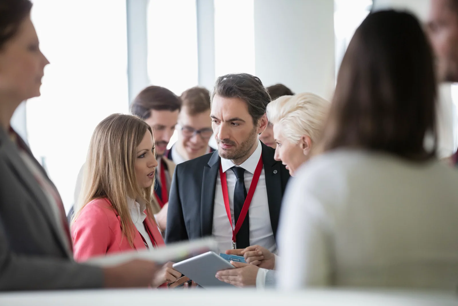 Event technology support desk with staff assisting laptops, tablets, printers, chargers, and connectivity issues