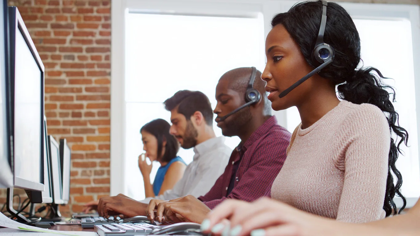 Temporary contact center with support agents using dual-monitor workstations, headsets, and printers during business continuity operations