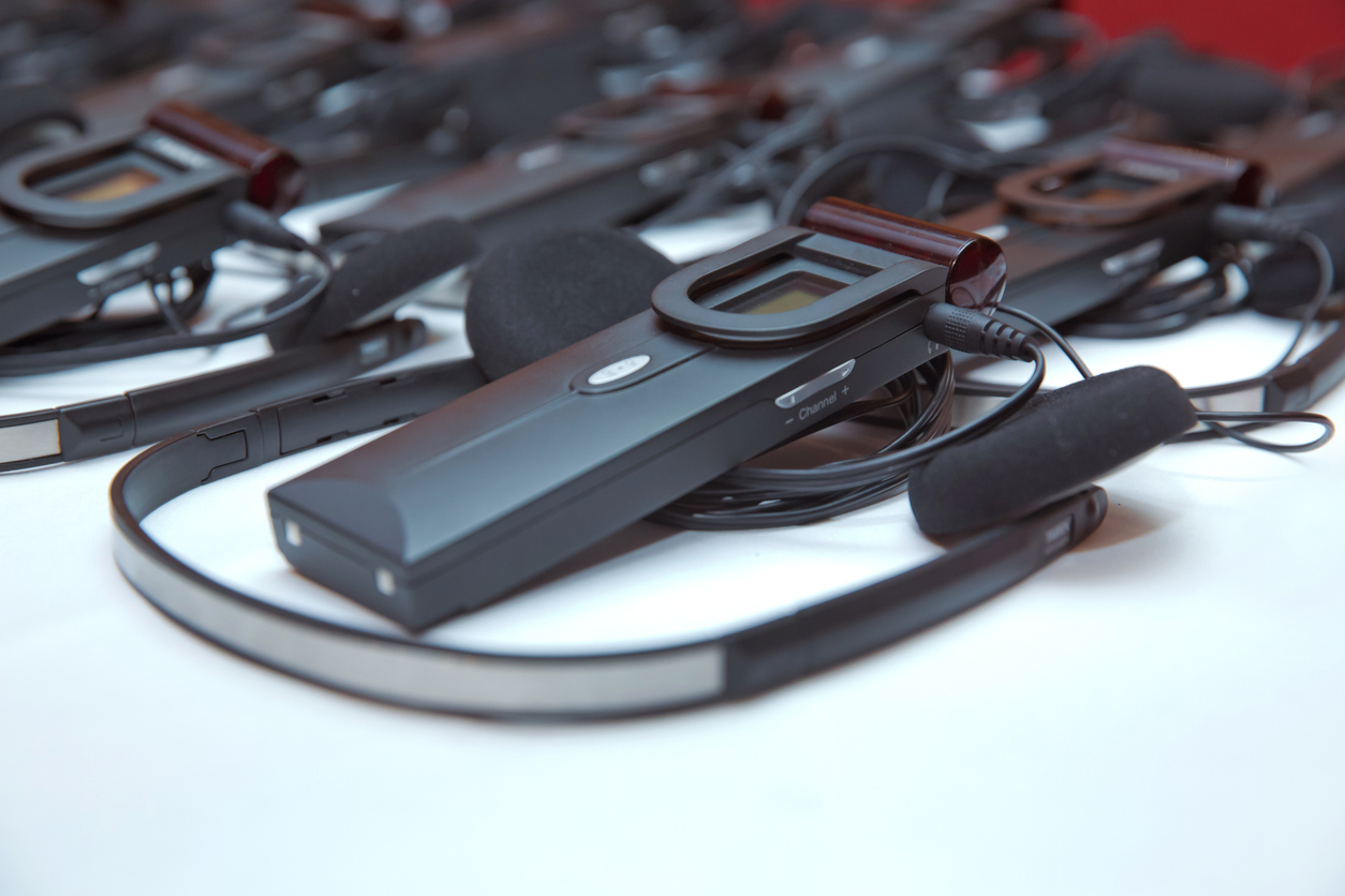 Wireless interpretation headsets and receivers for multilingual event attendees